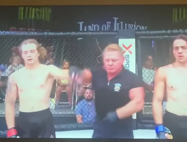 The referee raises Nathan Johnson's hand after his debut, on the LFS broadcast filmed off a TV