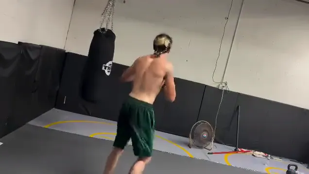 Nathan Johnson working the heavy bag in an empty gym