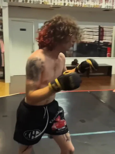 Nathan Johnson sparring (a practice fight) with a partner at the gym